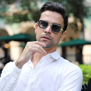Close-up of silver rectangle steampunk sunglasses with black lenses on a model