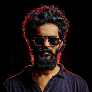 Steampunk square gold metal sunglasses for men with dark lenses on a bearded model