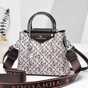 Detail of printed crossbody bag with metal handle and wide jacquard logo shoulder strap
