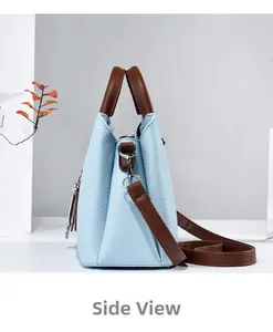 Side view of light blue tote bag with brown handles and silver hardware detail