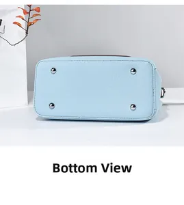 Detail view of the light blue leather bucket bag bottom with four silver metal feet