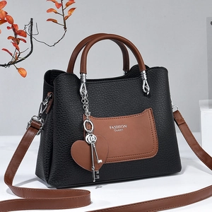 Litchi pattern black and brown trapezoid handbag with FASHION Queen logo and heart charm
