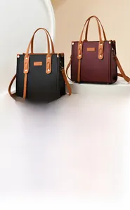 Detail of lychee pattern leather tote bags in black and wine red for business commute