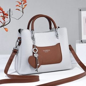 White and brown leather handbag with Fashion Queen print and heart key charm