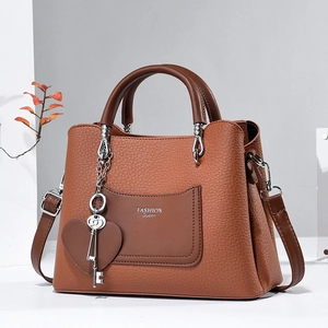 Brown litchi grain PU leather handbag with FASHION Queen print and heart charm
