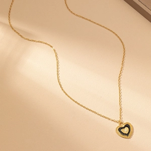 Elegant gold chain necklace featuring a black heart pendant with a golden sunburst design