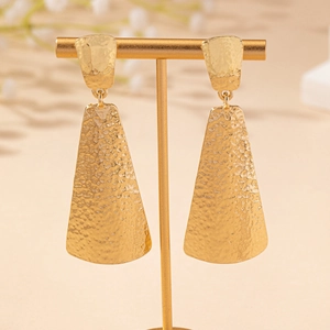 Golden long geometric earrings with hammered metal texture and modern vintage design