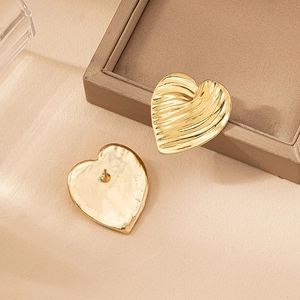 Elegant gold heart stud earrings with vintage wavy texture and metallic finish for daily wear