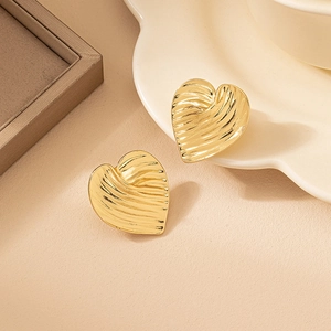 Elegant gold heart-shaped earrings with unique wavy pleated texture for a vintage look
