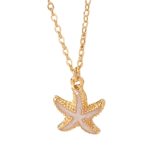 Golden starfish pendant necklace with pink enamel detailing on a fine chain jewelry