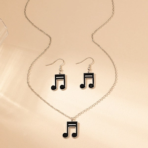 Vue détaillée du collier et boucles d'oreilles notes de musique en émail noir