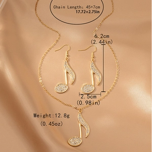 Elegant gold-tone musical note necklace and earrings set with white pave rhinestones