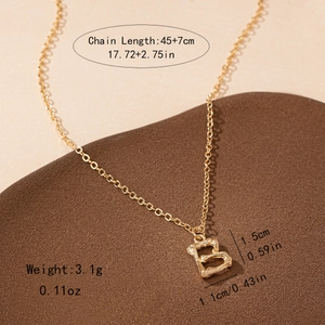 Detail of golden letter B pendant with bamboo texture and 45cm plus 7cm chain length
