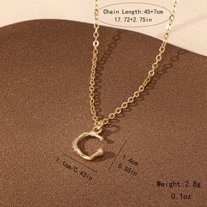 Detail of gold bamboo texture letter C pendant with specific size and weight labels