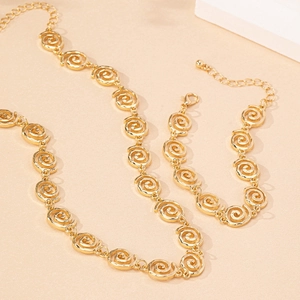 Elegant gold-tone jewelry set with spiral link necklace and matching bracelet for women