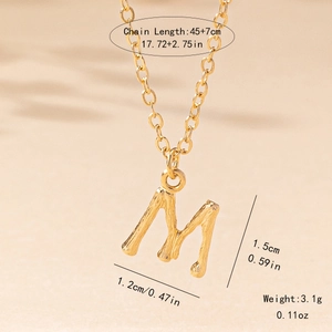 Detail view of gold letter M pendant with bamboo texture and 45+7cm chain measurements