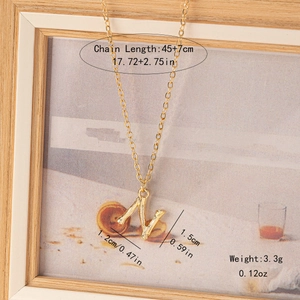 Detail of gold letter N necklace with bamboo texture showing length and weight specs