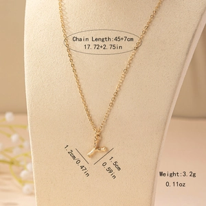 Detail of gold letter Y necklace with bamboo texture pendant on a jewelry display stand