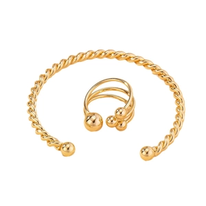 Golden twisted bangle and layered bead ring set featuring a minimalist vintage design