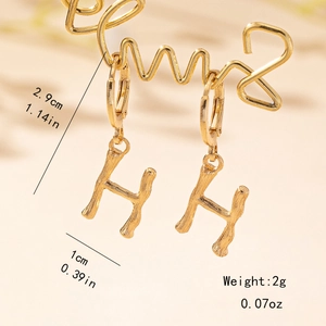 Detail view of gold bamboo texture letter H earrings with size and weight measurements