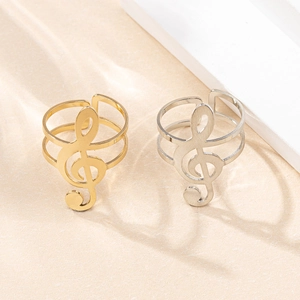Macro view of adjustable treble clef rings in gold and silver polished finishes