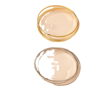 Polished triple-layer bangle bracelet set in gold and silver finish on white background