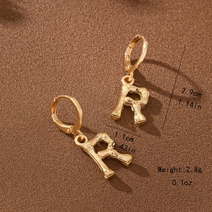 Detail of gold letter R bamboo hoop earrings with dimensions 2.9cm height and 1.1cm width