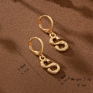 Detailed view of golden S-shaped bamboo textured drop earrings with size specifications