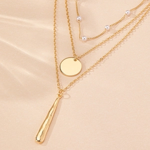 Elegant gold layered necklace featuring white pearls, round disc, and teardrop pendants