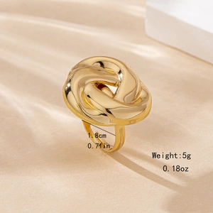 Gold chunky twisted rope ring with 1.8cm diameter shown on a soft beige background
