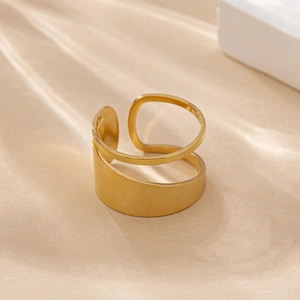 Detailed side view of a polished gold-plated open ring with irregular hollow design
