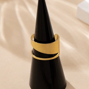 Elegant gold wrap ring with double-layer hollow design on a black display stand