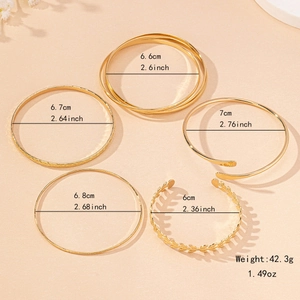 Set of five elegant gold-tone bangles with diverse textured and minimalist designs