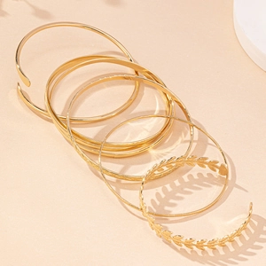 Elegant set of 6 gold-plated bangles including leaf design and geometric patterns