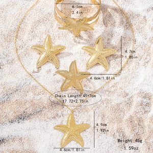 Parure bijoux étoile de mer dorée avec collier et bracelet sur fond de sable fin
