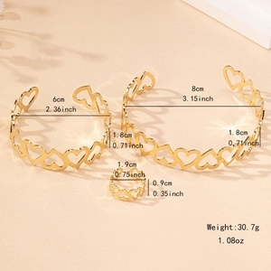 Elegant gold hollow heart jewelry set featuring two open bangles and a matching ring