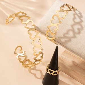 Elegant gold hollow heart jewelry set featuring an open bangle and matching ring