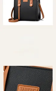 Detailed view of the litchi pattern leather and brown brand logo on black tote bag