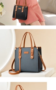Detail of lychee pattern leather tote bag with contrasting straps and metal rivets