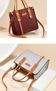 Detail of contrasting synthetic leather tote with lychee texture and brand label