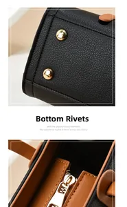 Detail of metal rivets on black lychee leather base and golden zipper of the large tote bag