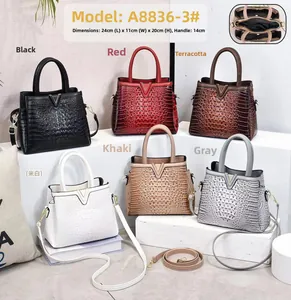 Close-up of crocodile pattern leather handbags in six colors with metallic V-shaped logo detail