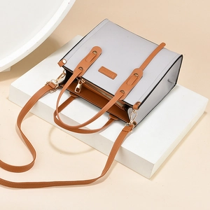 Minimalist colorblock tote bag in grey and tan faux leather with adjustable strap