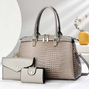 Grey lizard-textured three-piece handbag set featuring a tote, wallet, and card holder
