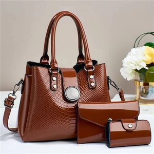 Detailed set of brown faux leather tote with crocodile pattern and matching pouches