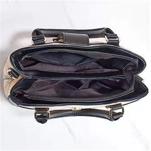 Top-down view of multi-compartment interior for black and beige large tote bag