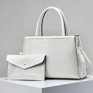 White faux leather crocodile embossed handbag set with gold hardware and small envelope clutch