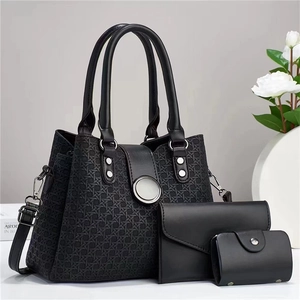 Black three-piece tote bag set with textured weave and silver ring details