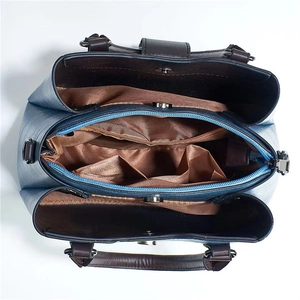 Top view of large crossbody bag showing interior compartments and textured blue leather