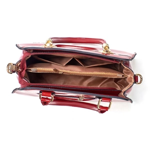 Red glossy patent leather tote bag with spacious interior compartments and gold zipper